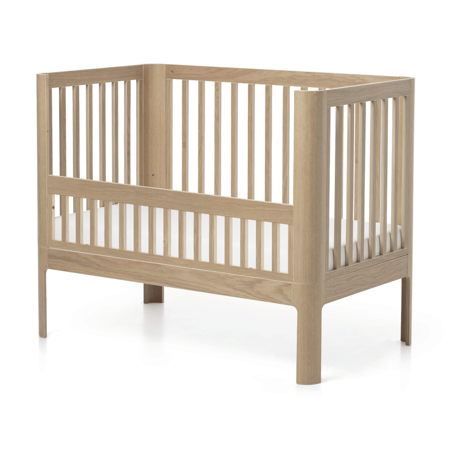 FLEXA NOVA oak baby bed rail with slatted sides and mattress, child-safe design, shown against white bedroom background.