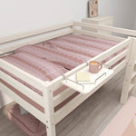 FLEXA loft bed in light wood with pink bedding, white FLEXA bedside table and soft pink rug in a child’s bedroom.
