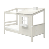 FLEXA WHITE single bed from the HOUSE collection with a ladder, slanted roof, window, and child-safe edges in a kids’ room.